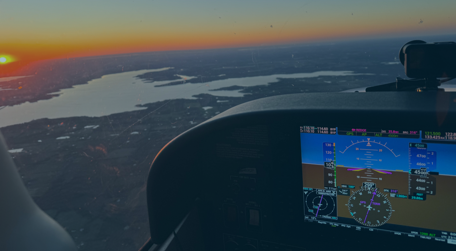 Pilot’s view of aircraft cockpit and skyline while receiving VFR Flight Following from air traffic control.
