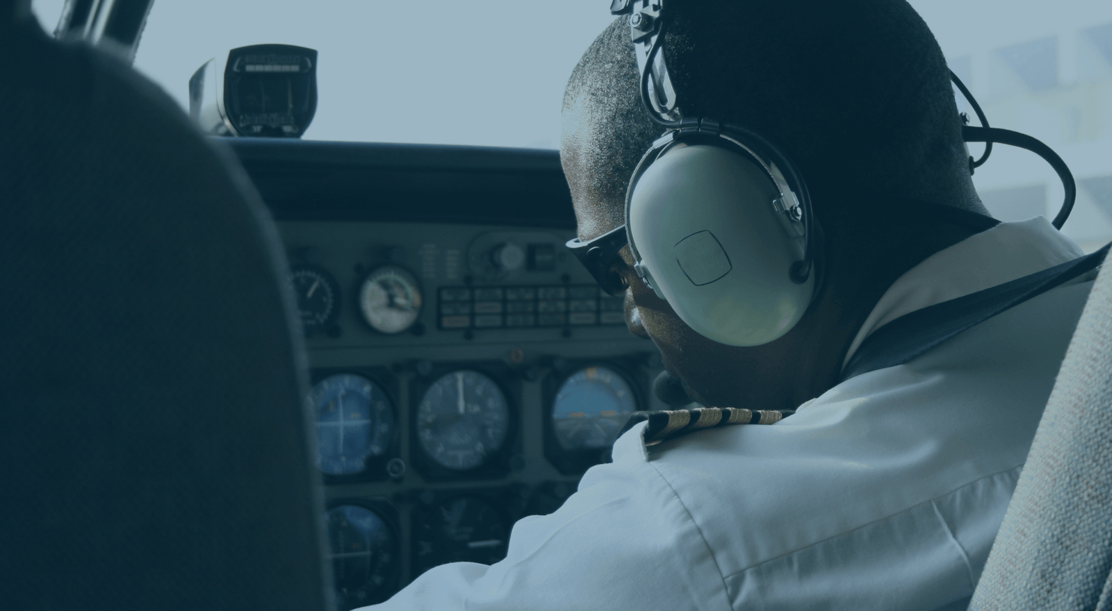 Pilot inside cockpit with instrument panel